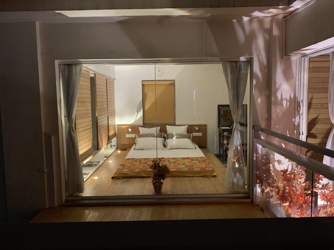 Bedroom viewed through a glass partition at night