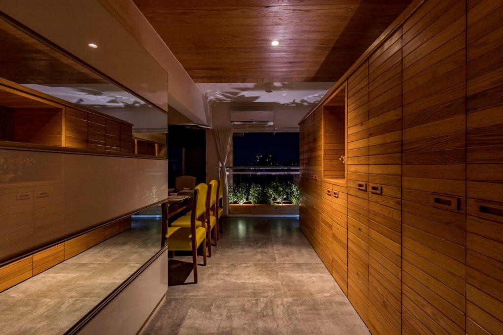 Teak-panelled dining passage opening to a balcony